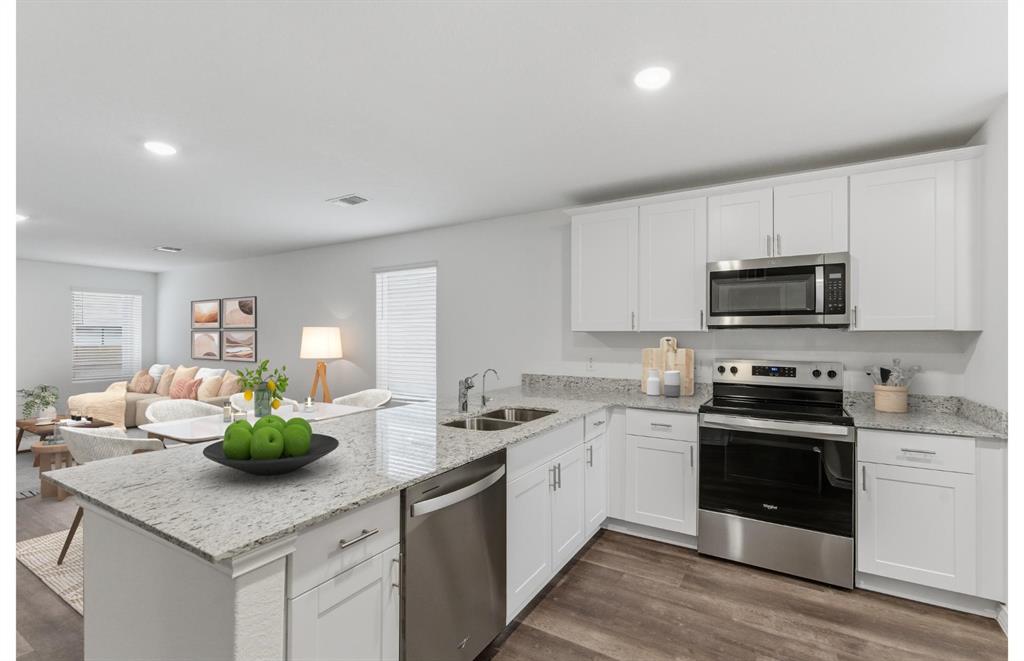 2534 Midfield Way Princeton, TX 75407 - Photo 7 of 14 a kitchen with stainless steel appliances granite countertop a sink a stove and cabinets