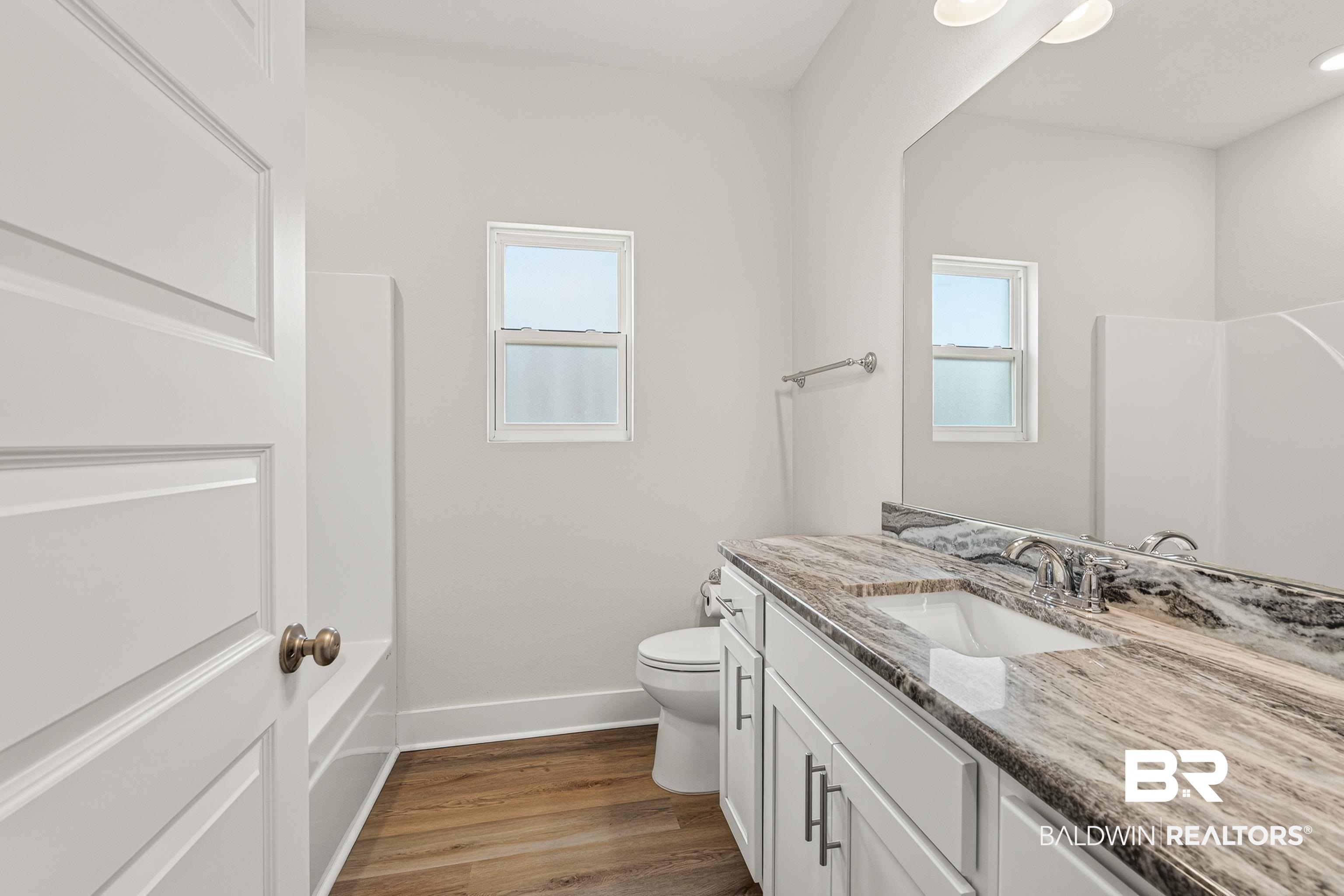 1724 Partridge Street Foley, AL 36535 - Photo 38 of 62 Bathroom featuring a vanity with a patterned countertop, integrated sink, and chrome fixtures