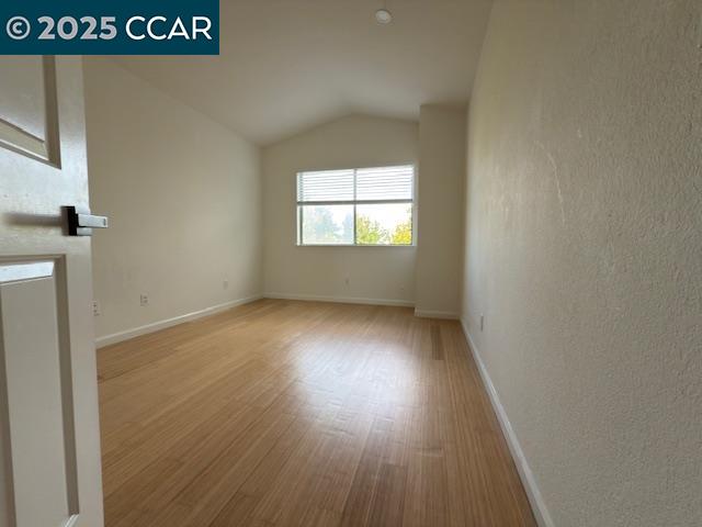 528 Dohrmann Lane Pinole, CA 94564 - Photo 14 of 16 an empty room with wooden floor and windows