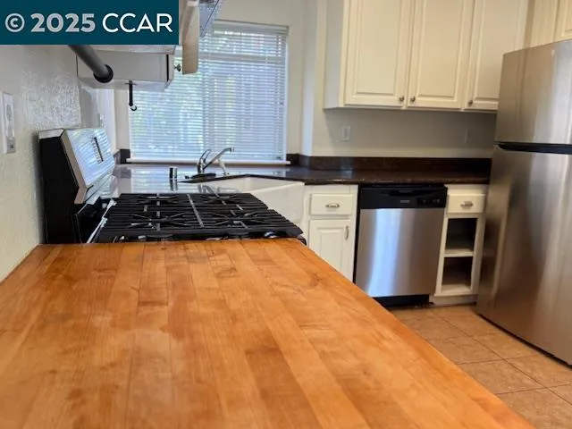 a kitchen with a sink a stove and cabinets