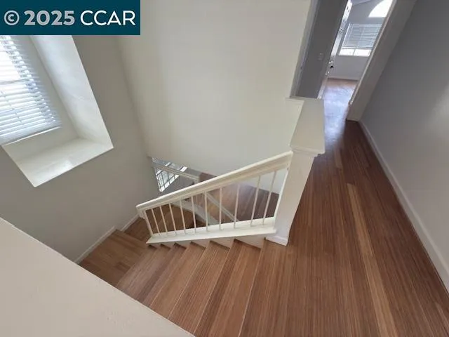 a view of a room with wooden floor and a window