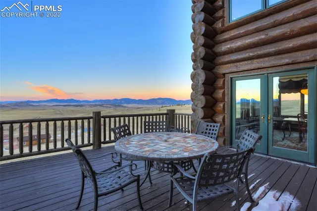 a view of a livingroom with furniture a window and wooden floor