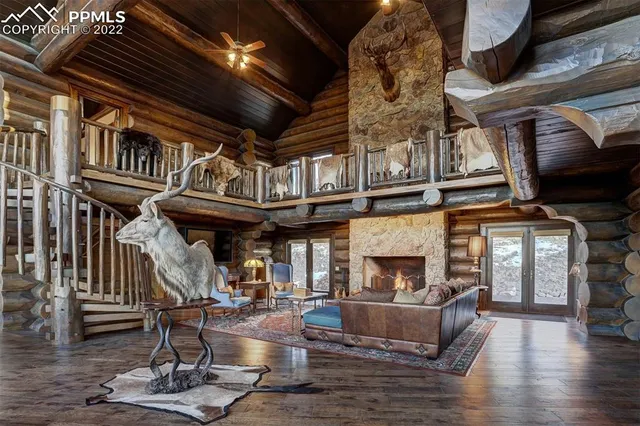 a view of a hallway with wooden floor and furniture