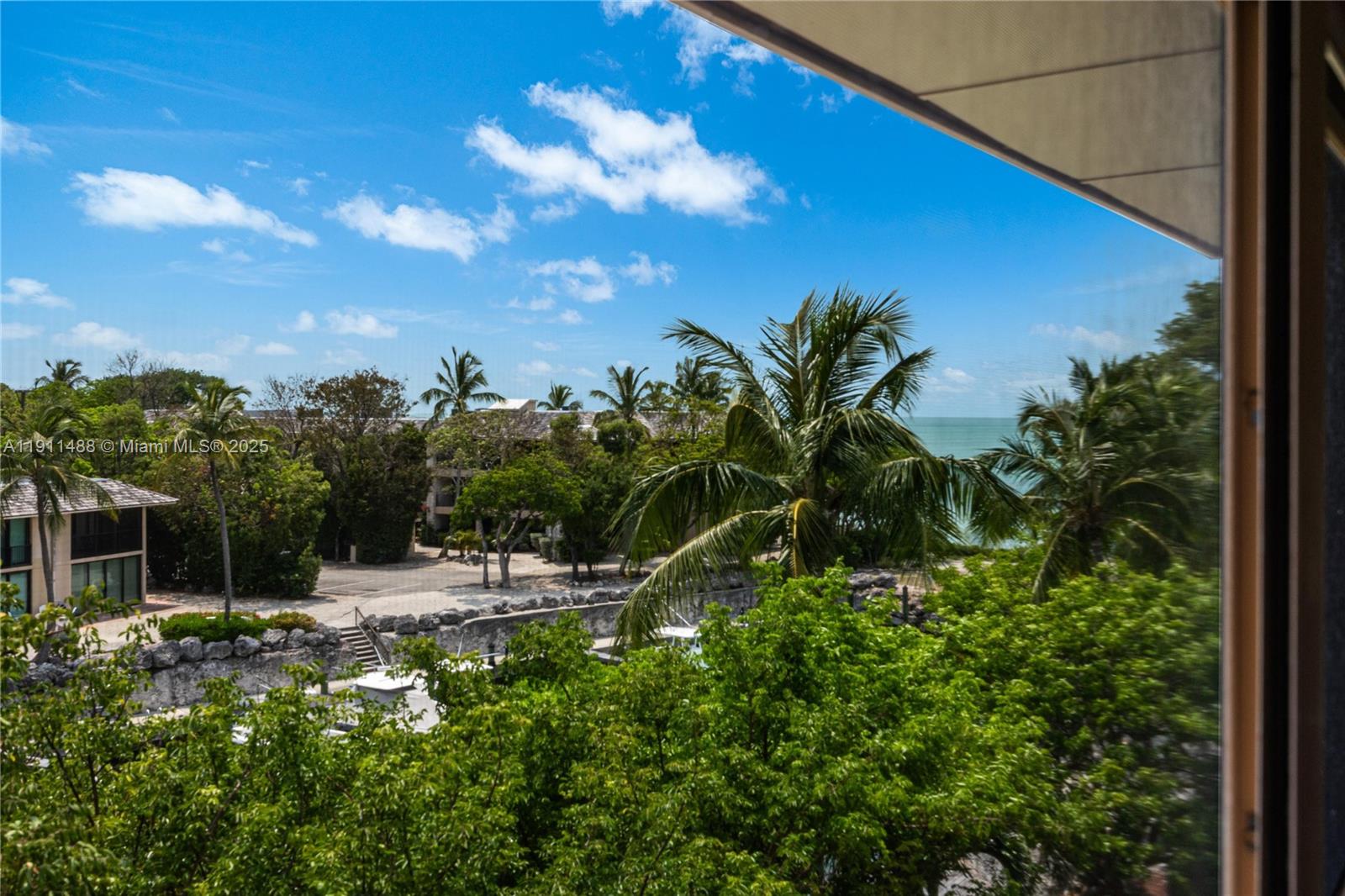 96000 Overseas Highway, Unit W44 Key Largo, FL 33037 - Photo 14 of 33 a view of a chair and tables in the patio