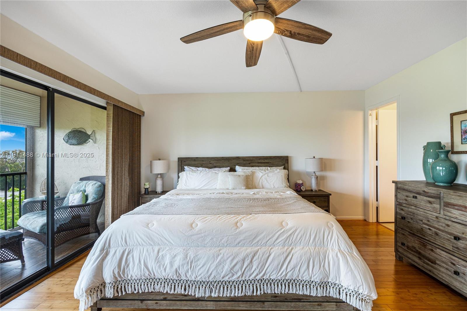 96000 Overseas Highway, Unit W44 Key Largo, FL 33037 - Photo 15 of 33 a bedroom with a bed and wooden floor