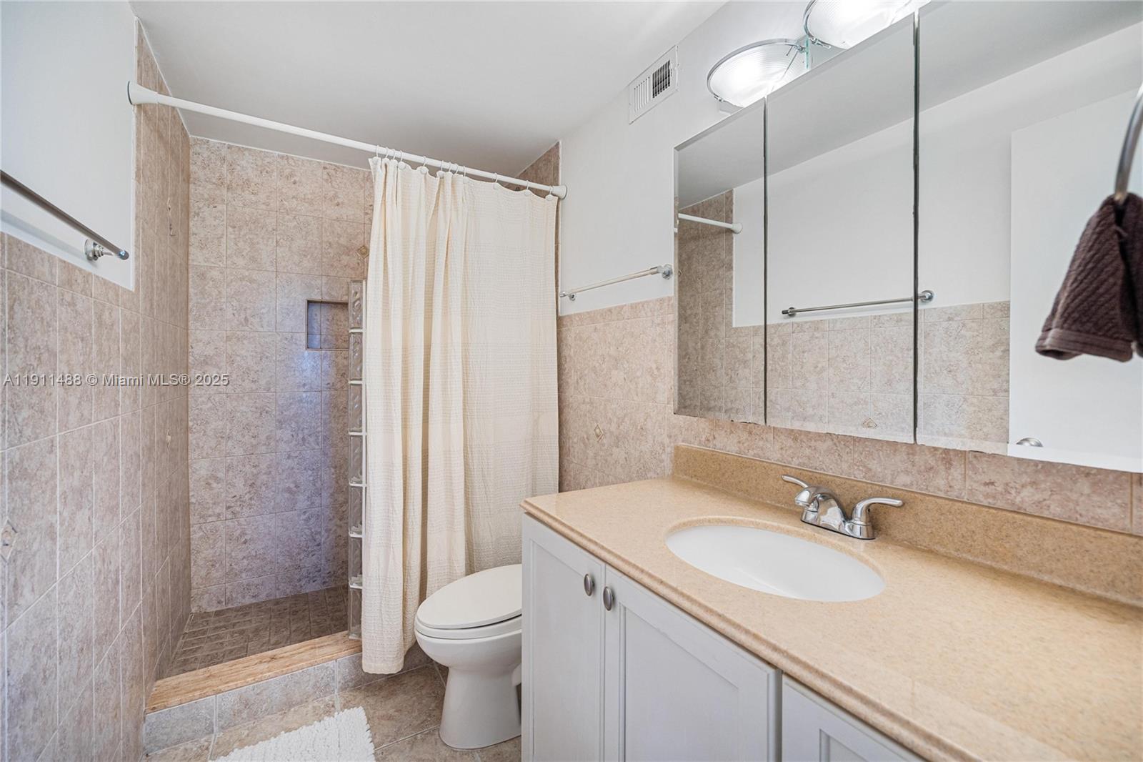 96000 Overseas Highway, Unit W44 Key Largo, FL 33037 - Photo 18 of 33 a bathroom with a sink toilet double vanity and shower