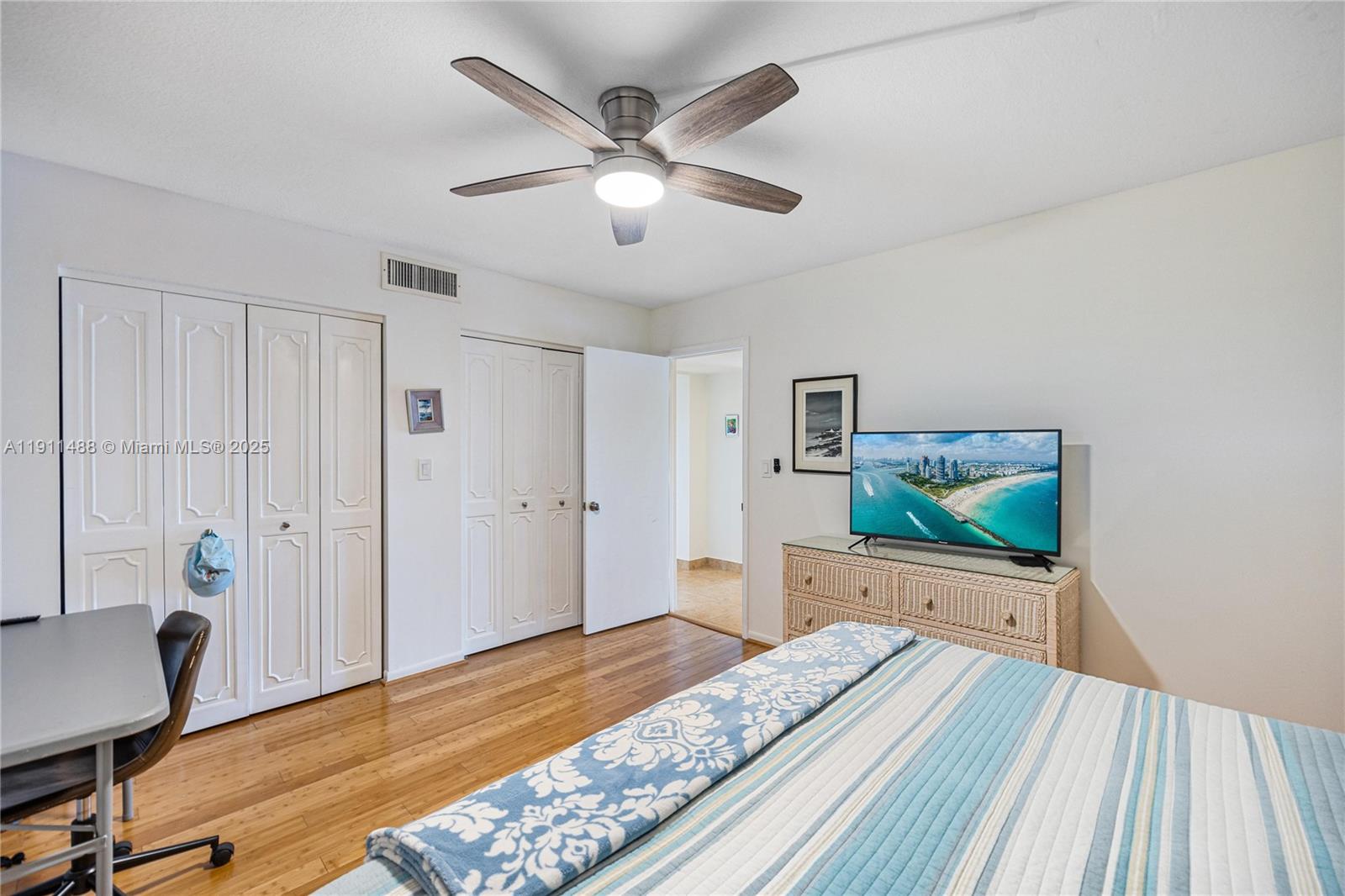 96000 Overseas Highway, Unit W44 Key Largo, FL 33037 - Photo 20 of 33 a bedroom with a bed and a dresser with wooden floor