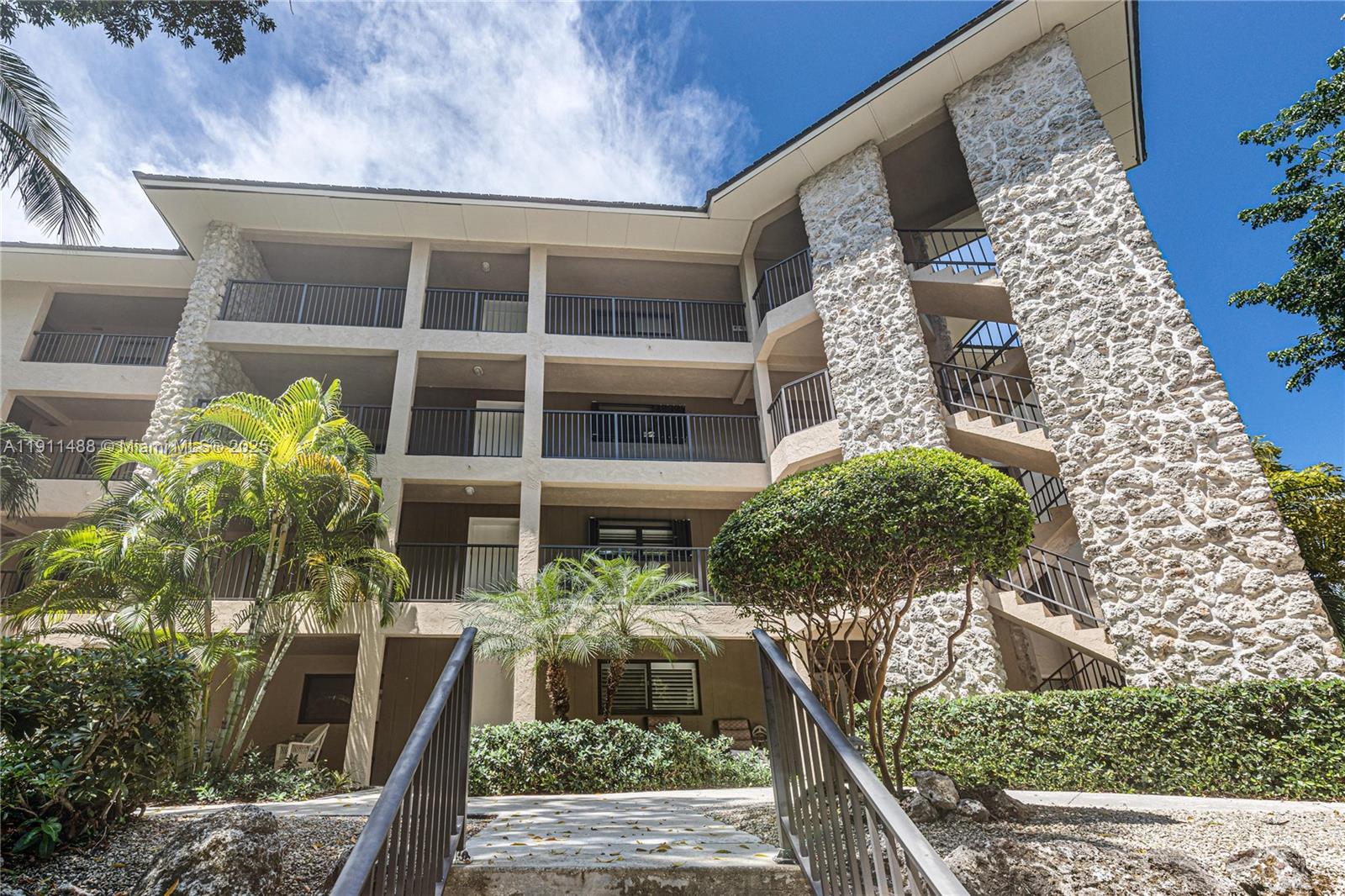96000 Overseas Highway, Unit W44 Key Largo, FL 33037 - Photo 2 of 33 a front view of a house with a yard