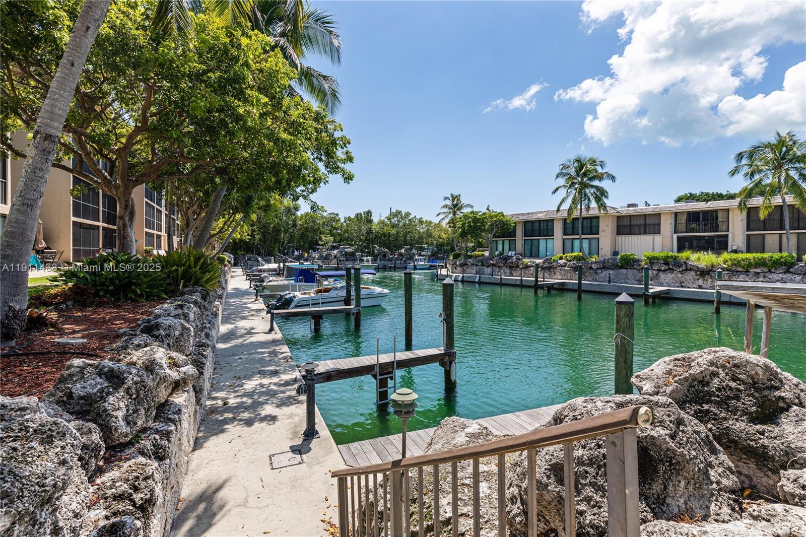 96000 Overseas Highway, Unit W44 Key Largo, FL 33037 - Photo 23 of 33 a view of a lake with a house