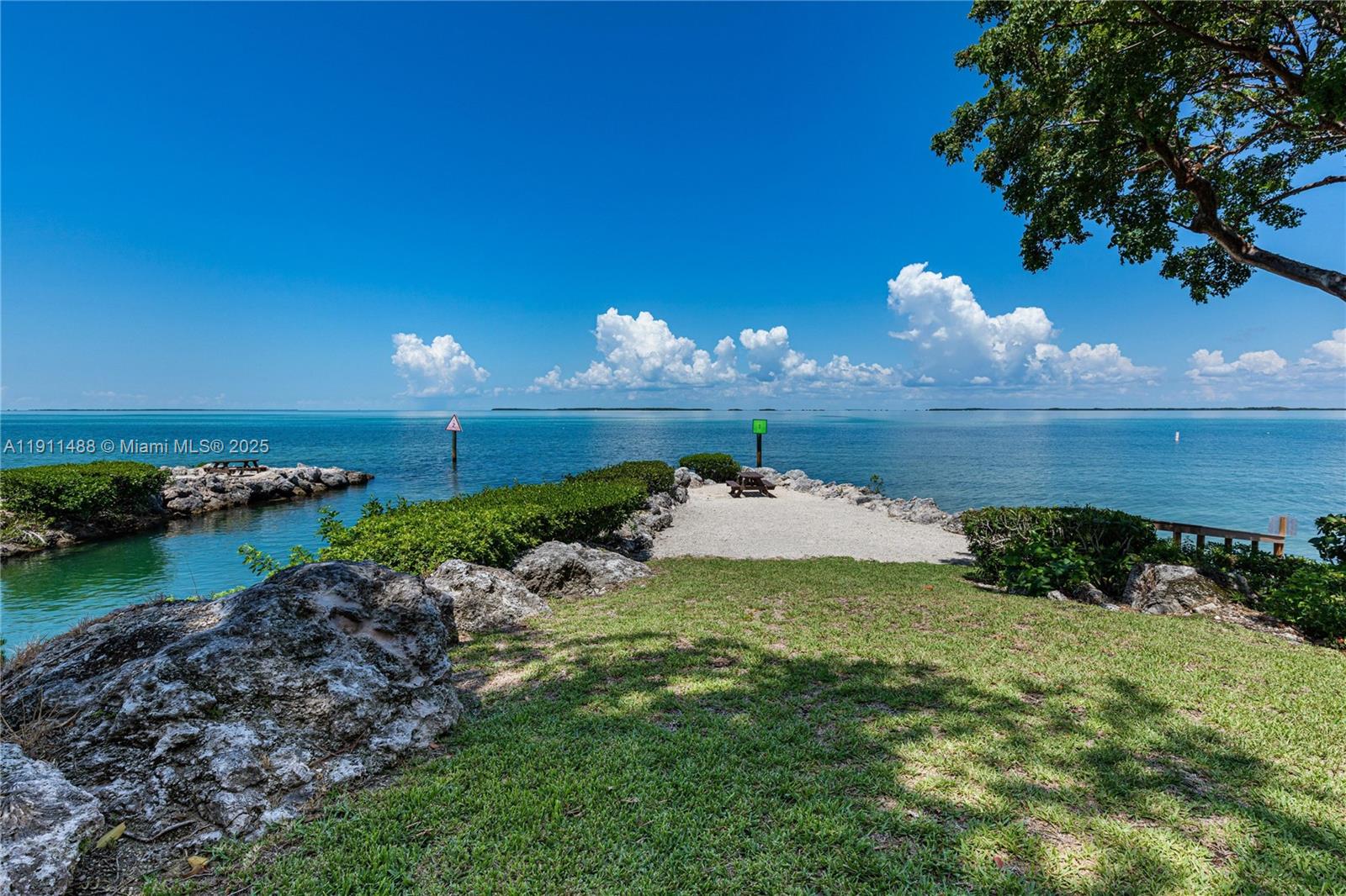 96000 Overseas Highway, Unit W44 Key Largo, FL 33037 - Photo 28 of 33 a view of a lake with a yard