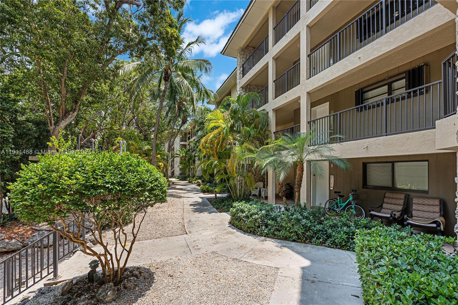 96000 Overseas Highway, Unit W44 Key Largo, FL 33037 - Photo 3 of 33 a view of a building with a yard