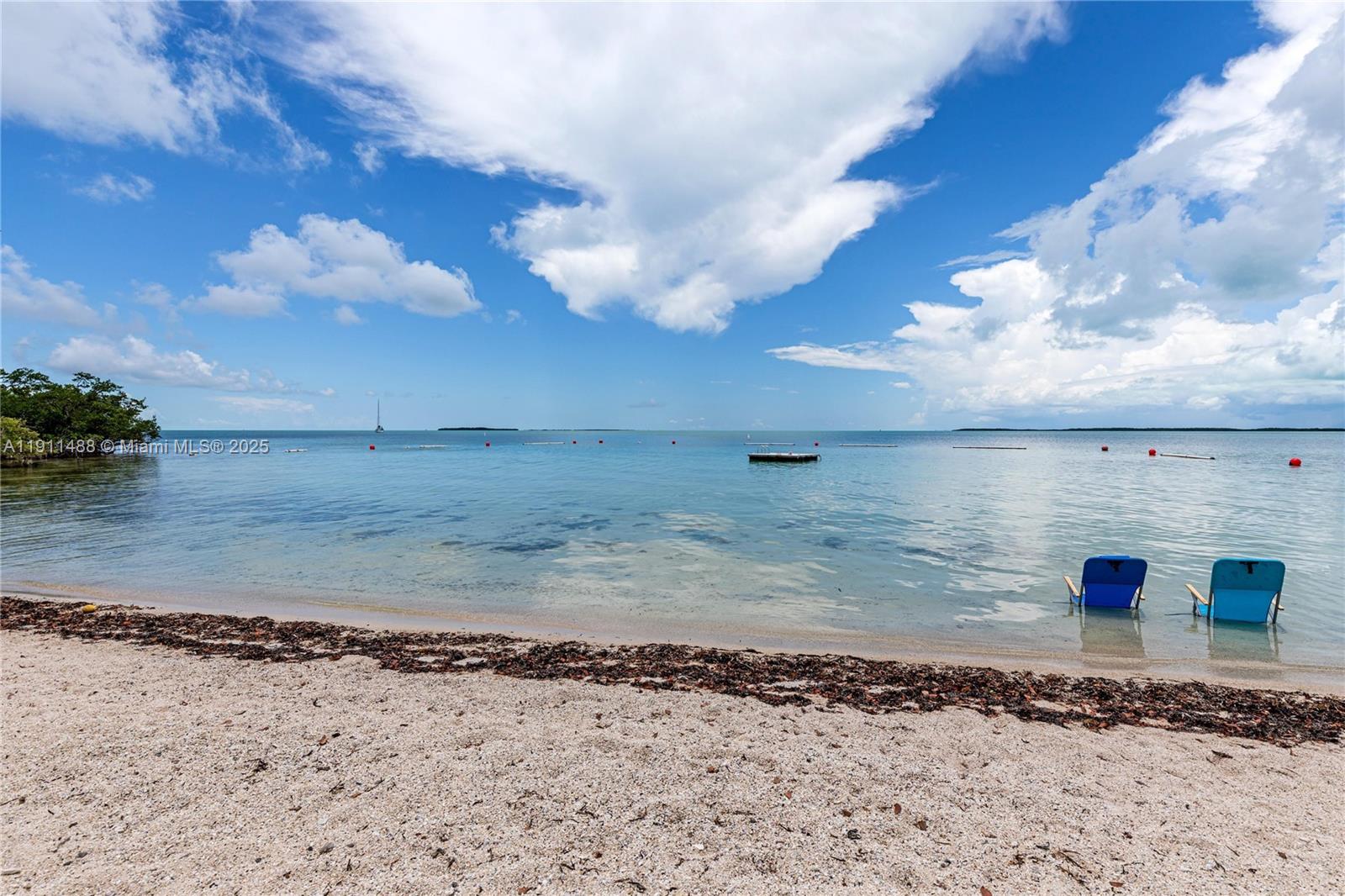 96000 Overseas Highway, Unit W44 Key Largo, FL 33037 - Photo 31 of 33 a view of a dry yard with wooden fence