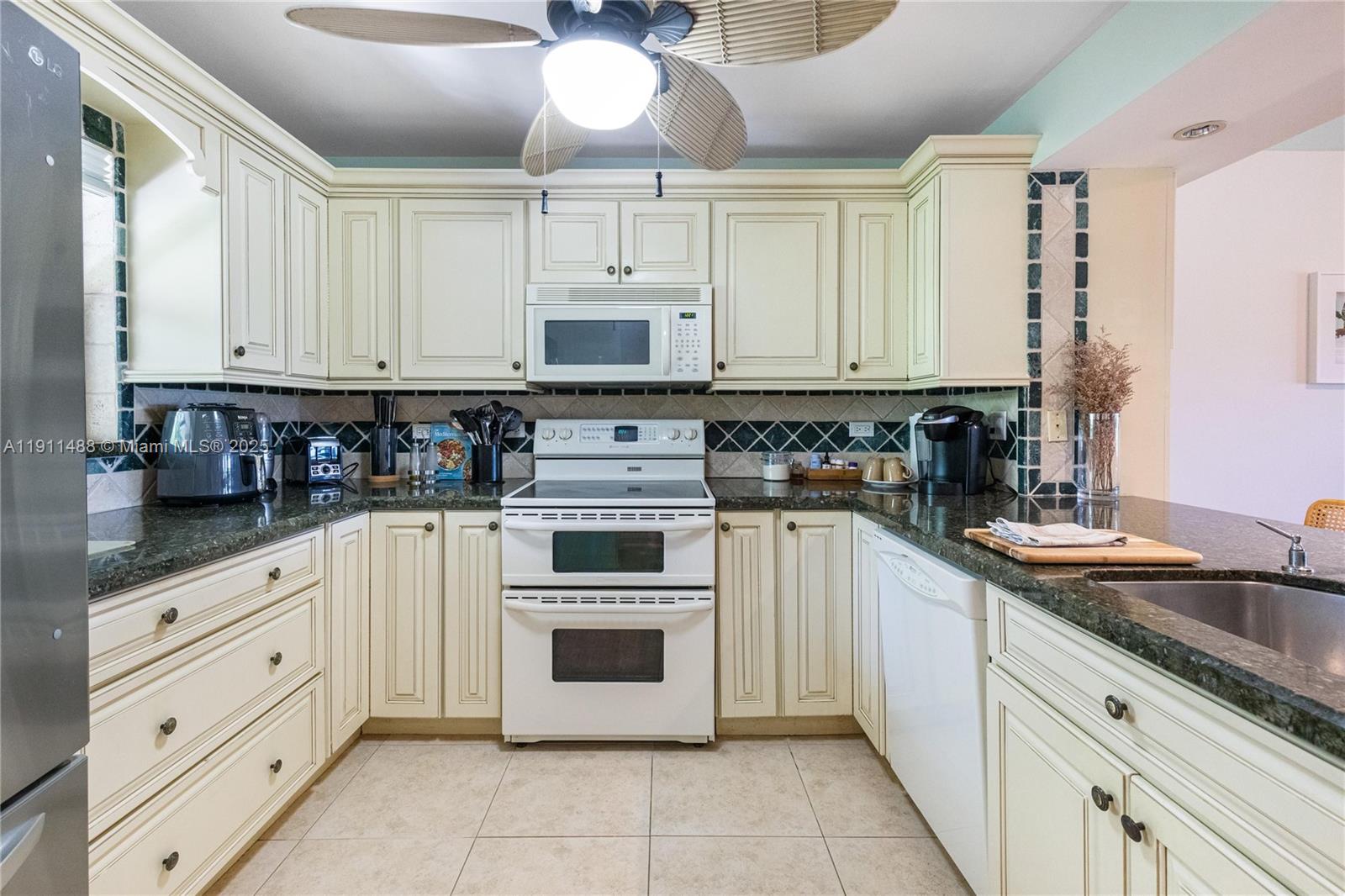 96000 Overseas Highway, Unit W44 Key Largo, FL 33037 - Photo 4 of 33 a kitchen with cabinets appliances and a sink
