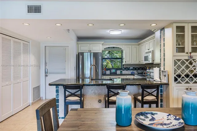 a kitchen with stainless steel appliances lots of counter space and breakfast area