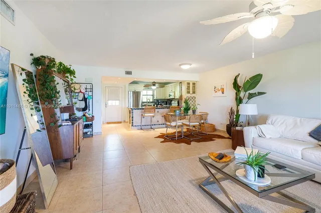a living room with furniture and a potted plant