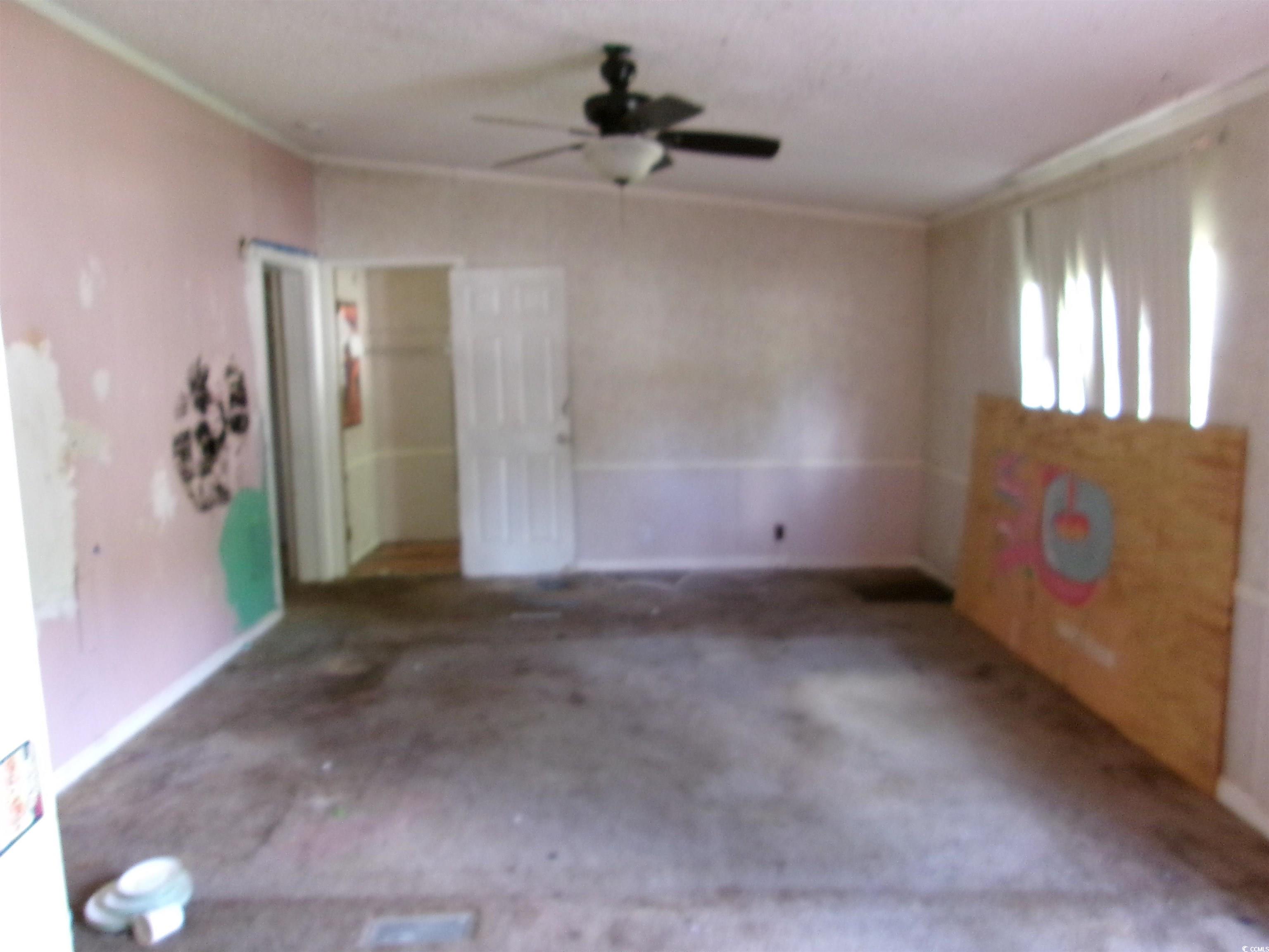 4261 Blake Road Myrtle Beach, SC 29588 - Photo 3 of 11 Carpeted empty room with crown molding and ceiling fan