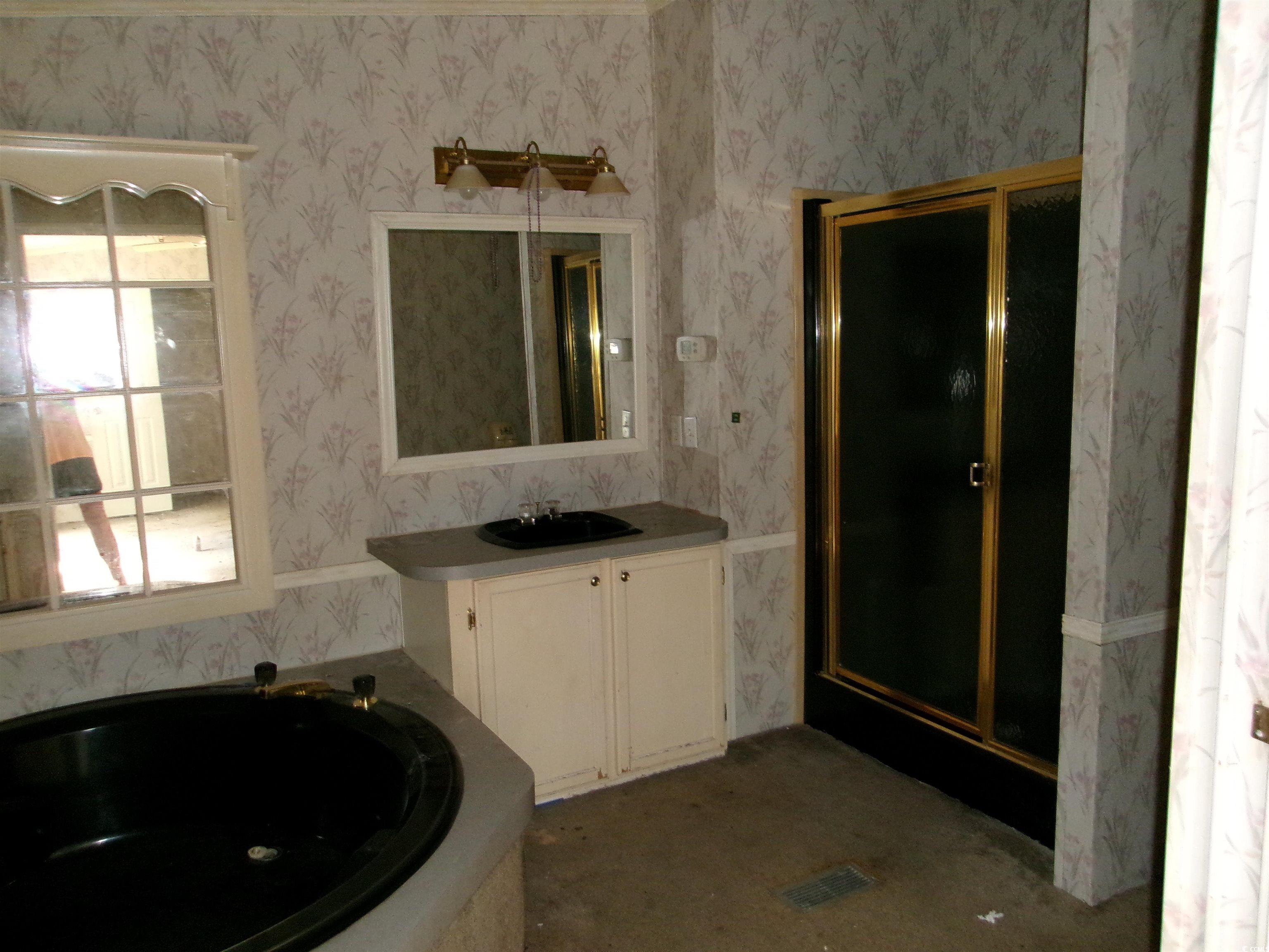 4261 Blake Road Myrtle Beach, SC 29588 - Photo 6 of 11 Full bathroom with vanity, a bath, a stall shower, and wallpapered walls