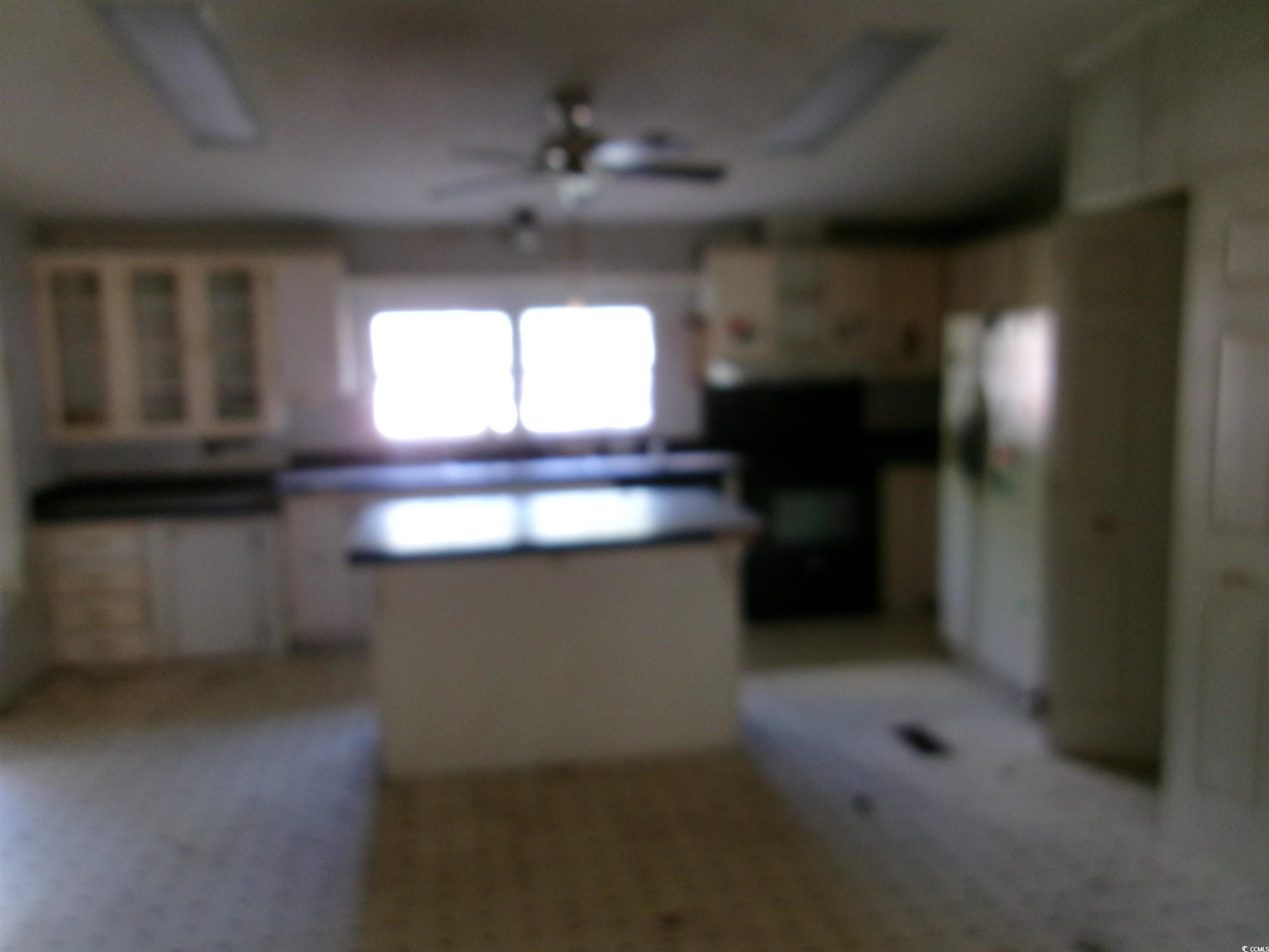 4261 Blake Road Myrtle Beach, SC 29588 - Photo 8 of 11 Kitchen with a ceiling fan and carpet floors