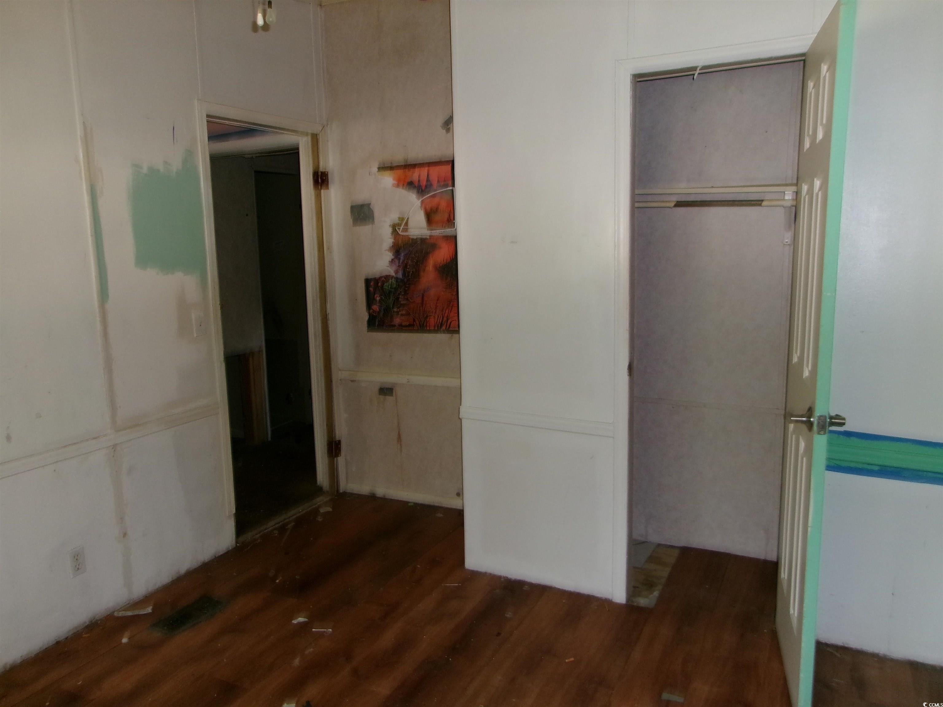 4261 Blake Road Myrtle Beach, SC 29588 - Photo 9 of 11 Unfurnished bedroom with wood finished floors and a closet