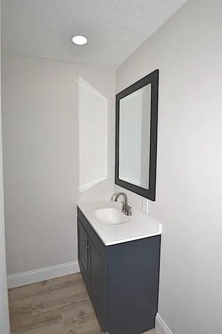 a bathroom with a sink vanity and mirror