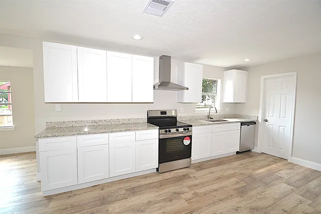 a kitchen with a sink a window and stainless steel appliances