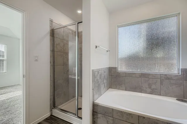 a bathroom with a bathtub and a shower
