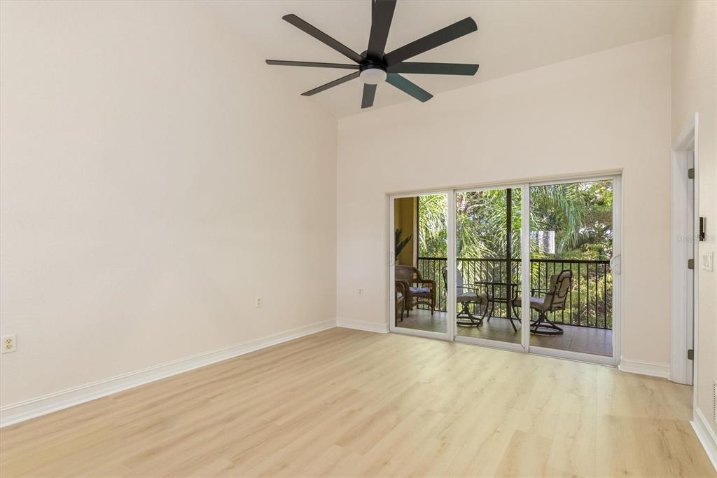 7196 North Plum Tree, Unit 323 Punta Gorda, FL 33955 - Photo 11 of 44 an empty room with chandelier fan and windows