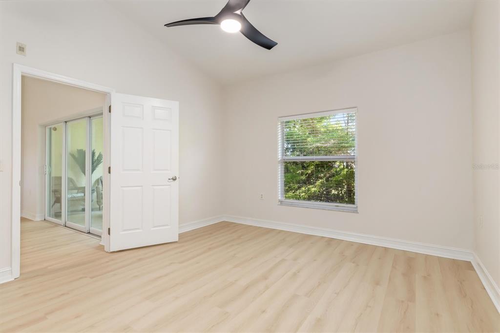 7196 North Plum Tree, Unit 323 Punta Gorda, FL 33955 - Photo 18 of 44 an empty room with wooden floor cabinet and windows