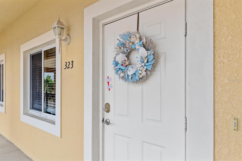 7196 North Plum Tree, Unit 323 Punta Gorda, FL 33955 - Photo 2 of 44 a view of a hallway with a glass door