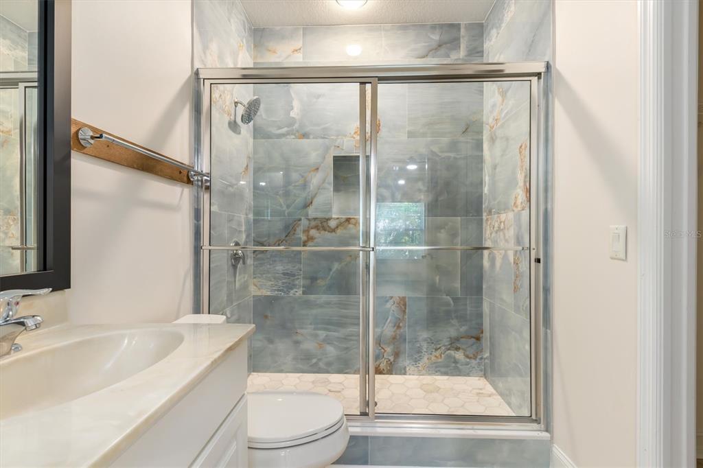 7196 North Plum Tree, Unit 323 Punta Gorda, FL 33955 - Photo 21 of 44 a bathroom with a shower a toilet and a sink