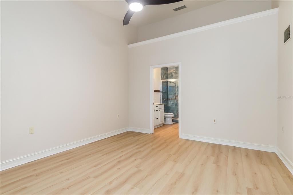 7196 North Plum Tree, Unit 323 Punta Gorda, FL 33955 - Photo 23 of 44 an empty room with wooden floor chandelier fan and closet
