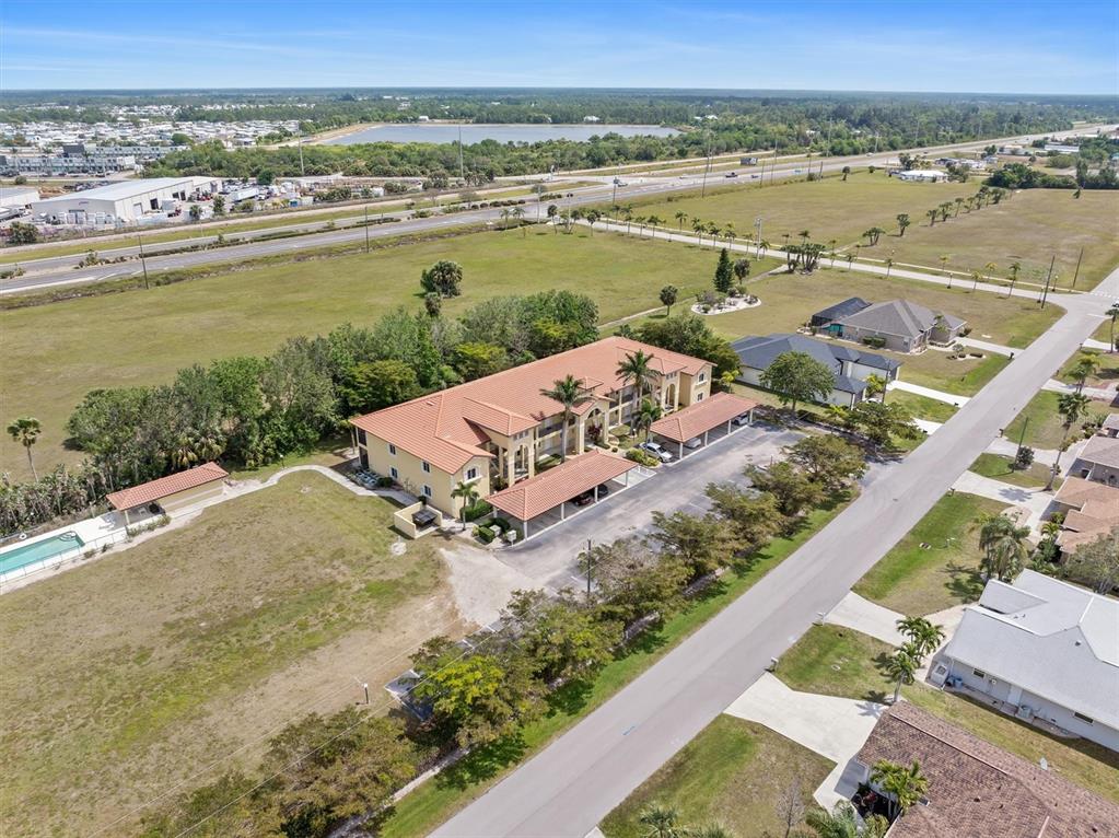 7196 North Plum Tree, Unit 323 Punta Gorda, FL 33955 - Photo 34 of 44 an aerial view of ocean and residential houses with outdoor space