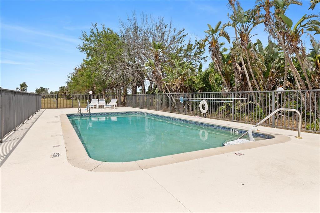 7196 North Plum Tree, Unit 323 Punta Gorda, FL 33955 - Photo 41 of 44 a view of a swimming pool with a yard