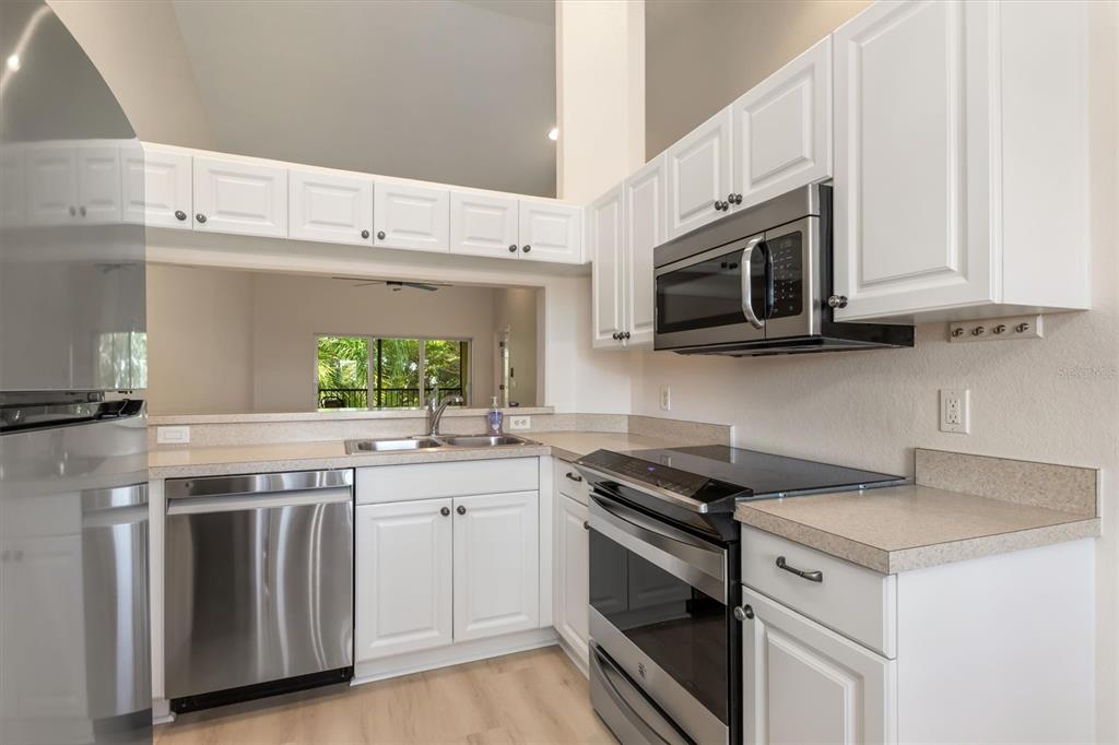 7196 North Plum Tree, Unit 323 Punta Gorda, FL 33955 - Photo 5 of 44 a kitchen with stainless steel appliances granite countertop a sink and a stove
