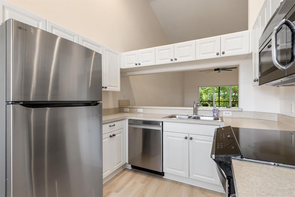 7196 North Plum Tree, Unit 323 Punta Gorda, FL 33955 - Photo 6 of 44 a kitchen with a refrigerator and a sink