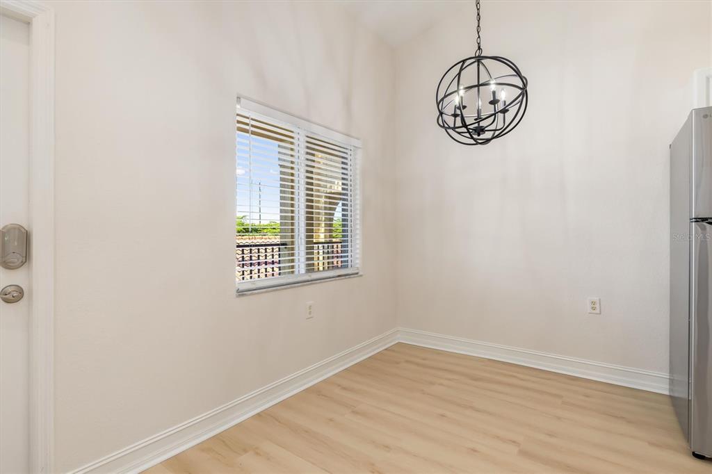 7196 North Plum Tree, Unit 323 Punta Gorda, FL 33955 - Photo 8 of 44 an empty room with wooden floor and windows