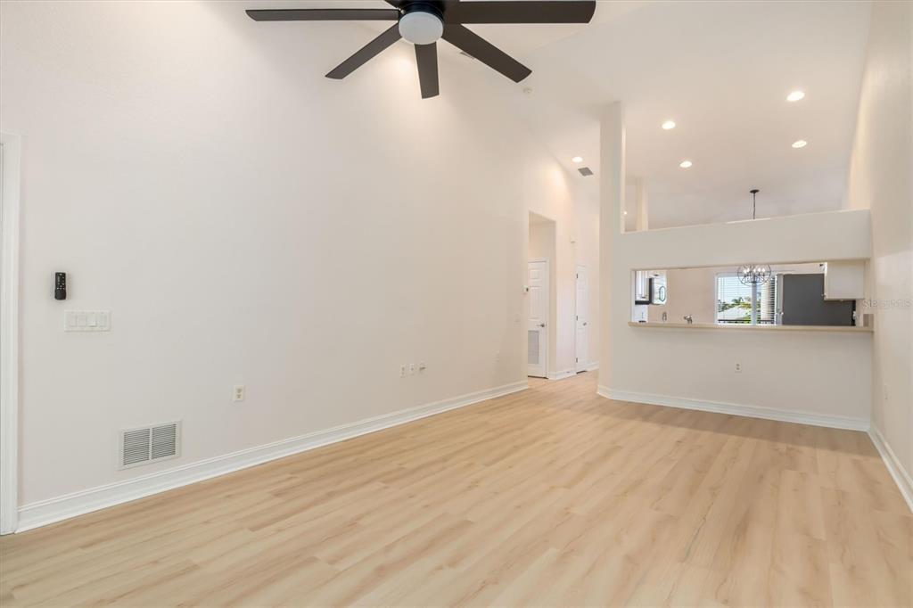 7196 North Plum Tree, Unit 323 Punta Gorda, FL 33955 - Photo 10 of 44 an empty room with wooden floor and windows