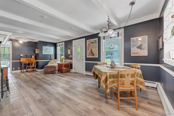 a living room with furniture a chandelier and a flat screen tv