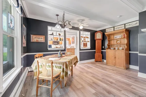 a view of a dining room with furniture window and wooden floor