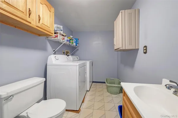 a bathroom with a sink mirror vanity and toilet