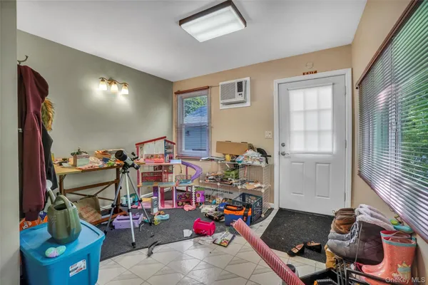 a room with gym equipment and a flat screen tv