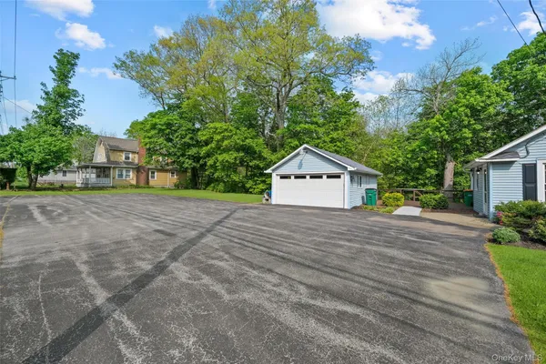 a front view of a house with a yard and trees