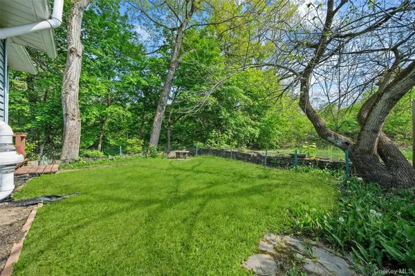 a view of green field with trees in the background