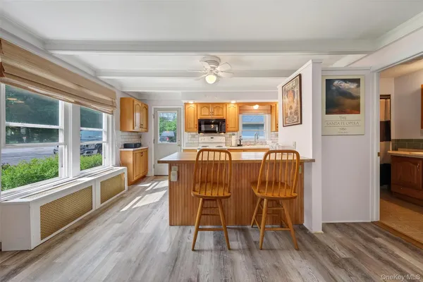 a view of a dining room with furniture window and wooden floor