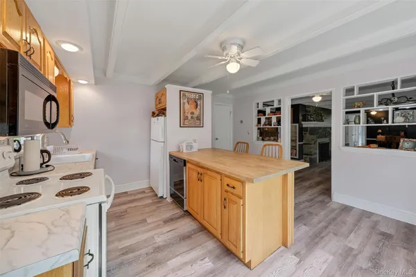 a view of kitchen with cabinets and wooden floor