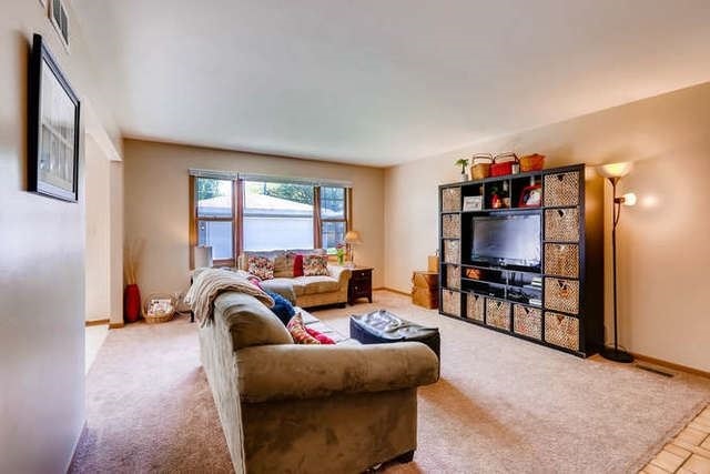 21301 West Willow Road Lake Zurich, IL 60047 - Photo 3 of 14 a living room with furniture a large window and a flat screen tv