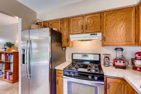 21301 West Willow Road Lake Zurich, IL 60047 - Photo 7 of 14 a kitchen with stainless steel appliances granite countertop a stove and a refrigerator