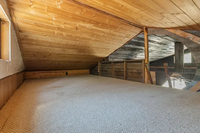 a view of an empty room with a staircase