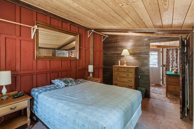 a bedroom with a bed and a dresser