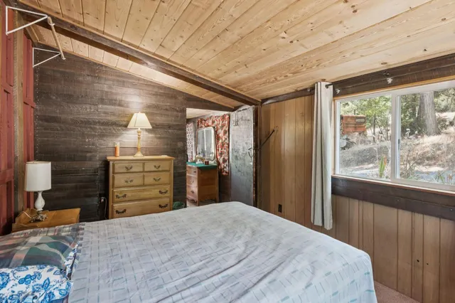 a bed room with a bed and a large window